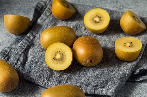 Three Different Varieties of Kiwi on a Black Wooden Table