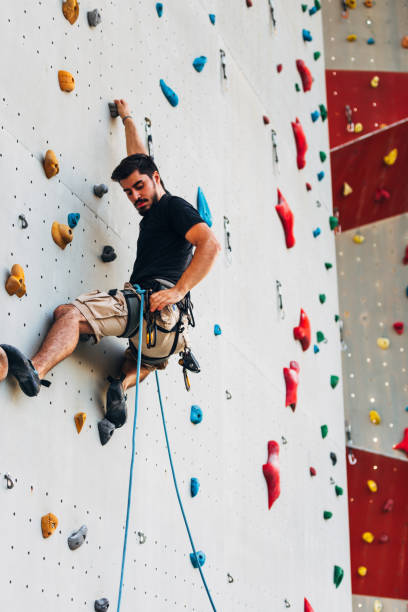 istock Young Caucasian man rock climbing outdoor 1361821346