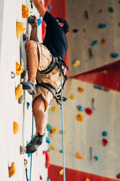 istock Young Caucasian man rock climbing outdoor 1361821351