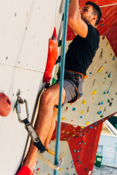 istock Young Caucasian man rock climbing outdoor 1361821378