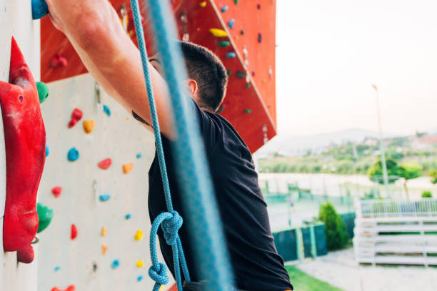 istock Young Caucasian man rock climbing outdoor 1361821380