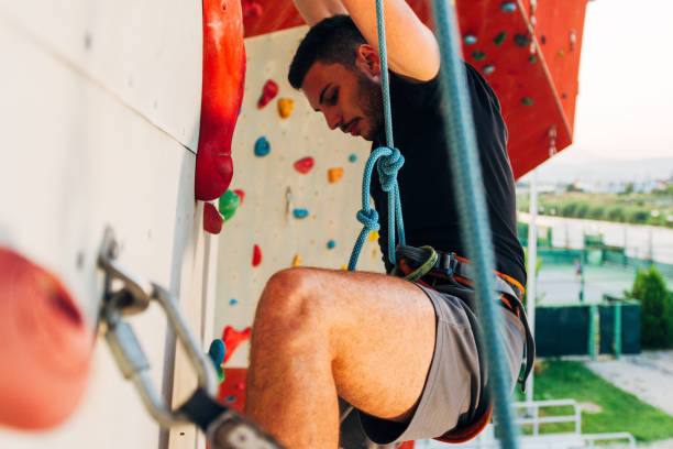 istock Young man exercising in climbing gym 1361821385