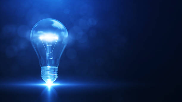 istock Creativity and new ideas. There is a light bulb on the left with bright white light. against a dark blue background. 1361826097