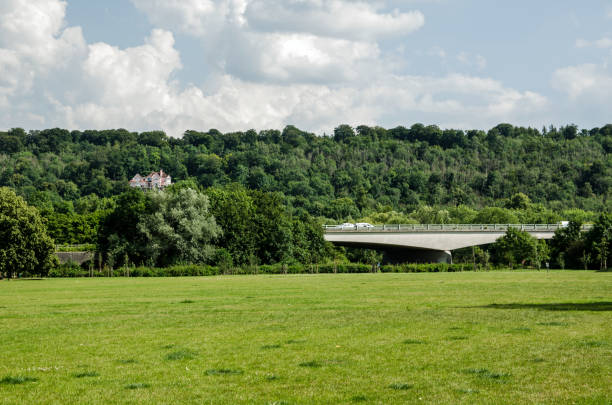 View on a sunny summer afternoon looking across the Gossmore Recreation Ground in Marlow towards the hill of Cookham Dean.  The Marlow by-pass bridge over the River Thames cuts through the scene.