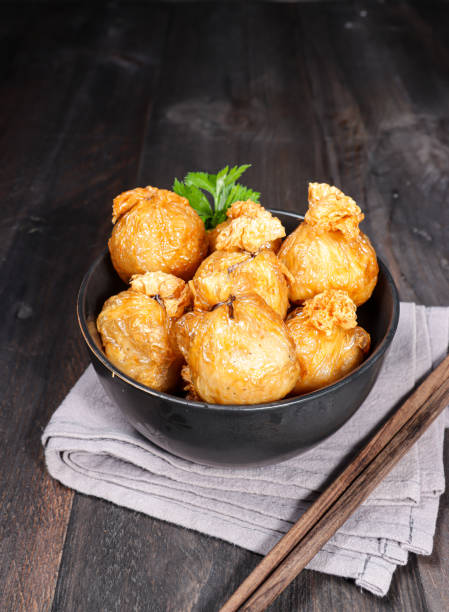 istock Ekado or ekkado is processed fish or shrimp meat wrapped in dumpling skin and shaped like a bag filling with cheese whose upper part is tied with chives. 1361829068