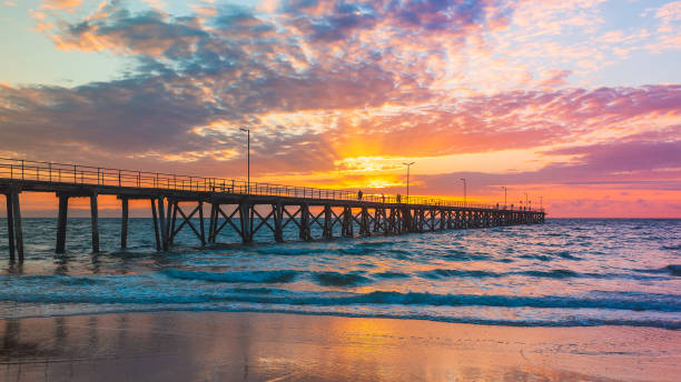 istock Pier with fishermen at sunset 1361829697