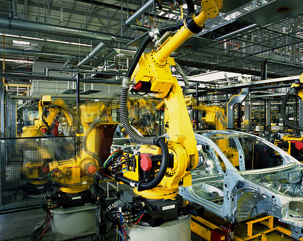 car production line yellow robots welding cars in a production line production line automobile industry car plant car stock pictures, royalty-free photos & images