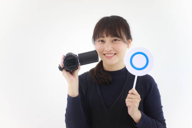 istock A woman with a video camera and a 〇 tag 1361842955