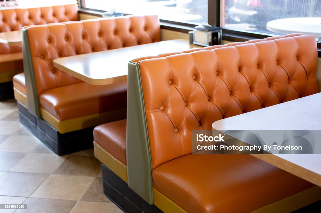 vintage restaurant bench A view of several vintage restaurant banquette style bench seating in a local burger restaurant in Los Angeles, California. Franchising Stock Photo