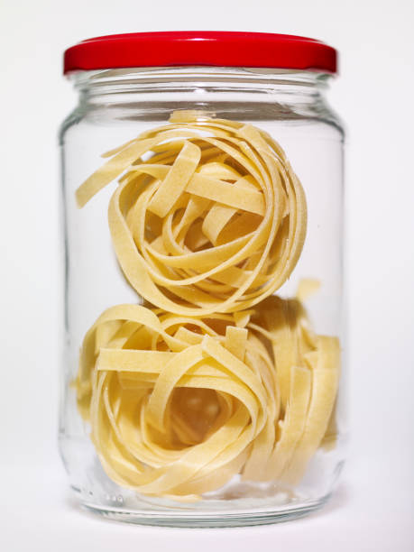 istock Pasta in glass jar on a white background 1361844851