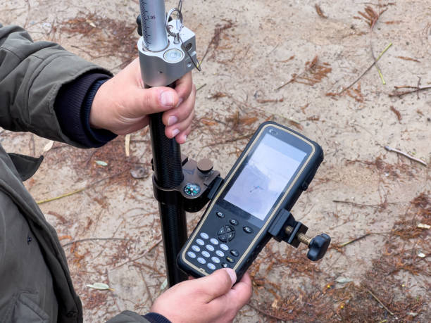 Engineer and Surveyor reviewing the GPS system and total station data using the GPS application.