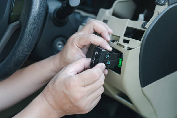 istock Close up hand Technician checking car headlight switch for maintenance to verify that the spare parts need to be replaced in service shop 1361845204