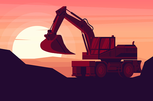 wheeled excavator in a sunset with heavy construction and mining machinery