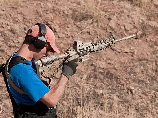 Man with AR-15 practicing target shooting.