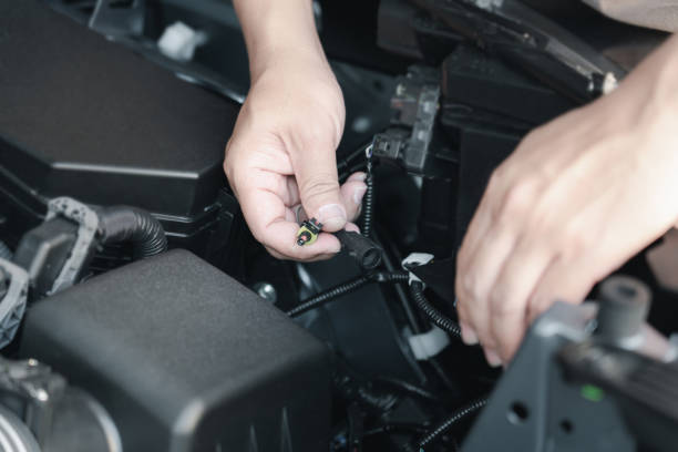 istock Close up hand a man plugging in for Xenon car headlights in engine room basic service concept do it yourself easily of car 1361850897