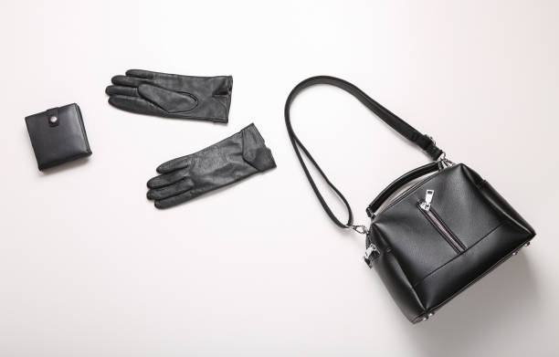 istock Leather bag, wallet and gloves on white background. Top view 1361851339
