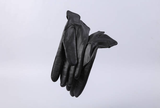 istock Classic black leather gloves levitating on gray background 1361851856