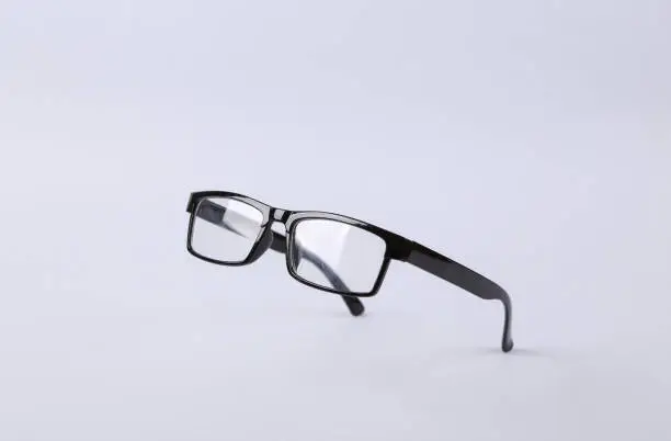 Photo of Levitating eye glasses on gray background