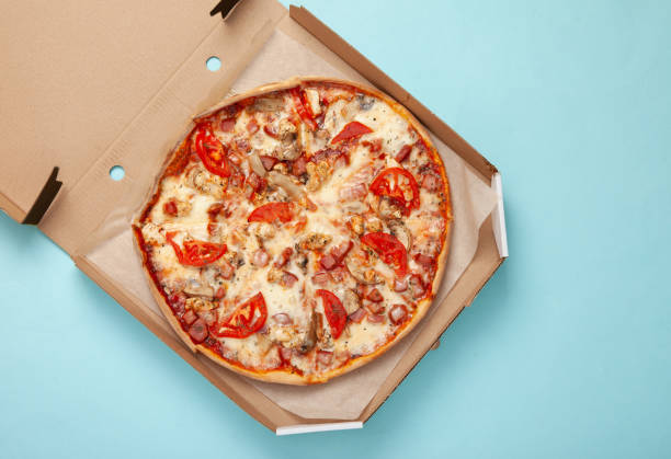 istock Pizza in an open box on blue background. Top view 1361852399