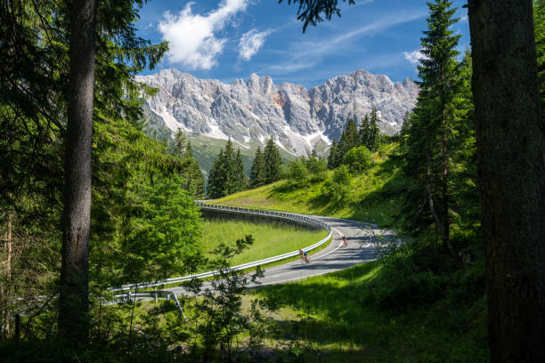 road cyclist on a mountain road in the alps, maria alm, salzburg, austria - road cycling imagens e fotografias de stock