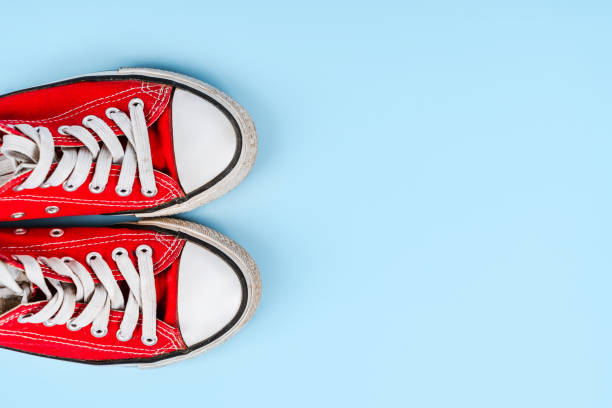 istock Red sneakers on a blue background. Minimalism 1361854040