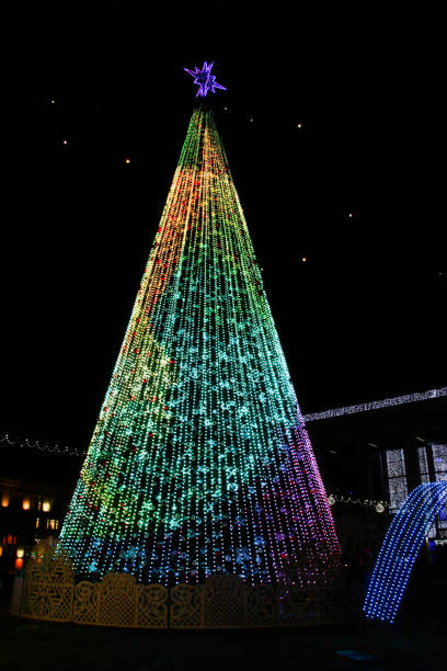 istock Artificial Christmas tree with multi-colored electric garlands. 1361858911