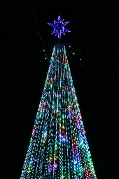 istock Artificial Christmas tree in garlands at night. 1361858914