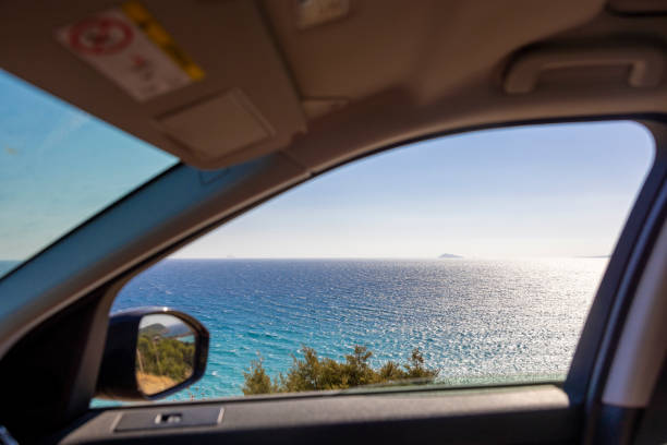 vista desde un coche en una pequeña isla en el mar mediterráneo, cerdeña, italia. - rear view mirror car mirror sun fotografías e imágenes de stock