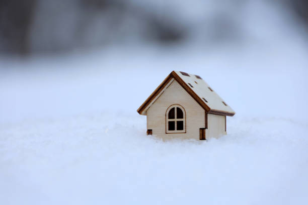 istock Wooden house model in a snow 1361860491