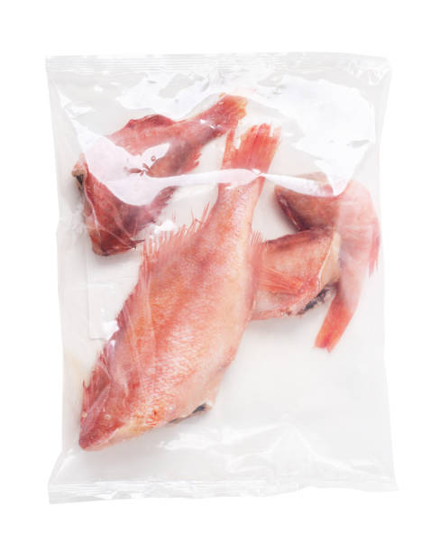 istock Frozen fish sea bass in plastic net bag isolated 1361861242