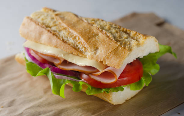 istock Fresh submarine sandwich with ham, cheese, tomatoes 1361861833