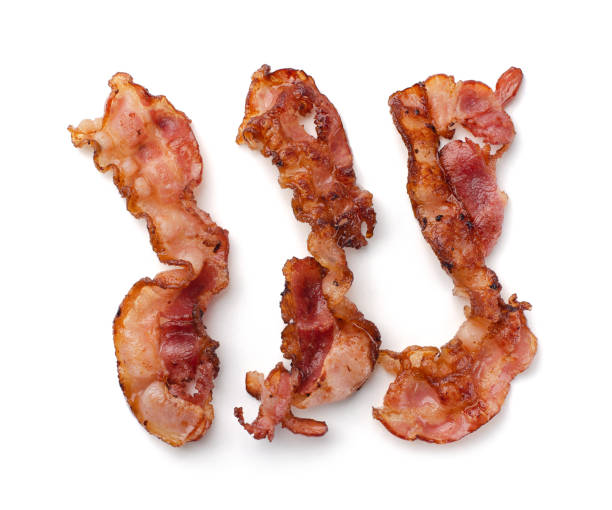 istock Three slices of fresh fried bacon lined up in a row isolated 1361861855