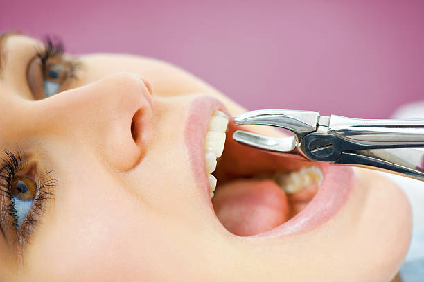 Young female patient takes a dental attendance in the dentist's office.