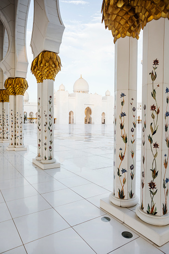 View through adorned columns on part of Sheikh Zayed Grand Mosque plateau and domes