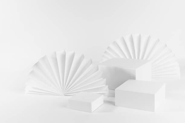 istock White abstract scene for presentation cosmetic produce or goods, advertising, design with three rectangle podiums on table, chinese white paper fans as elegant fashion decor, side view, corner, 3d. 1361867480