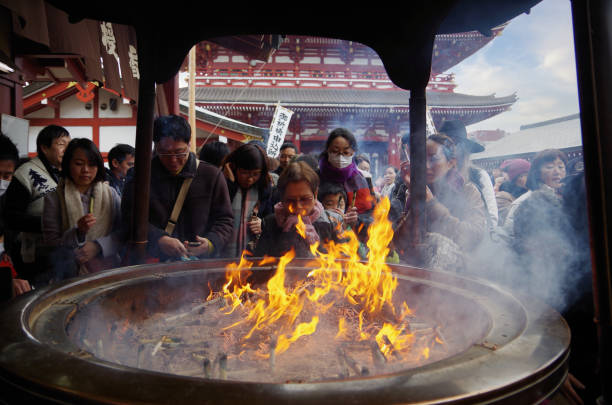 Senso-ji Temple of New Year Day Asakusa,Tokyo Japan - January 1, 2015:Here is the Senso-ji Temple of New Year Day in Asakusa,Japan.Many Japanese people visit temple to pray for happiness and good health. The first prayer in a year is called the ’Hatsumoude’. Sensoji Temple is the oldest temple in Tokyo.This is a big incense burner. When we expose to the smoke of incense burner, it is said that the bad place of our body will have been healing. japanese blacksmith workshop stock pictures, royalty-free photos & images