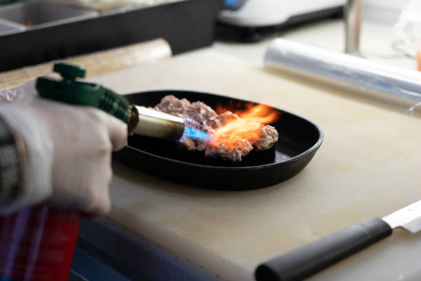 istock chef bakes sushi with fire in a restaurant 1361870070