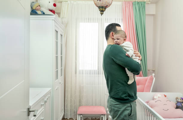 istock Baby in Daddy's Arms 1361871316