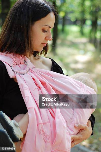 Breastfeeding Baby In A Sling Stock Photo - Download Image Now - Breastfeeding, Baby Carrier, Adult