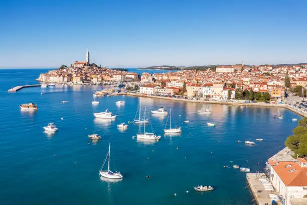 an aerial view of Rovinj, port with boats and ships, in background church of St. Euphemia, Istria, Croatia