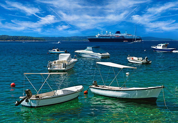 Boats at  turquoise harbor. Adriatic sea, Hvar island, Croatia, stock photo
