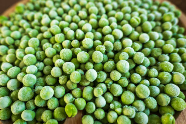 istock frozen frosty green peas background closeup 1361876232