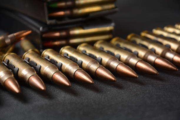 photo of 5.56mm nato ammunition, machine gun bullets belt, rifle ammunition in magazines - bullet ammunition gun rifle imagens e fotografias de stock