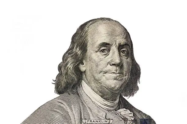 Benjamin Franklin cut from new 100 dollars banknote on white background