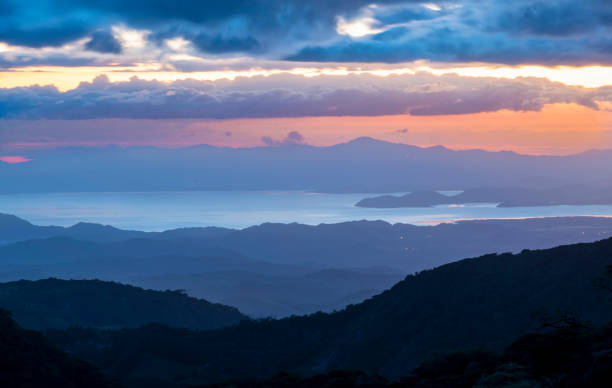 foothills of monteverde. panoramic view in beautiful orange sunset. santa elena in costa rica highlands. - monteverde cloud forest imagens e fotografias de stock