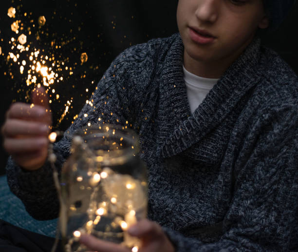 istock Kid with a jar full of lights in his hands 1361884104