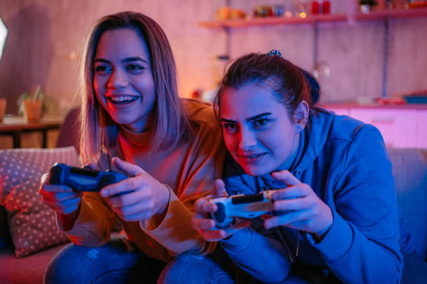 istock Lesbian couple playing videogames together 1361895022