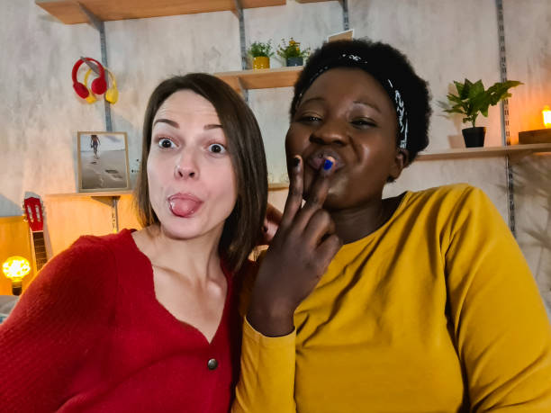 istock Female friends taking a selfie at home 1361896659