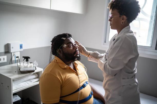 istock Doctor preparing patient's for polysomnography (sleep study) 1361897434