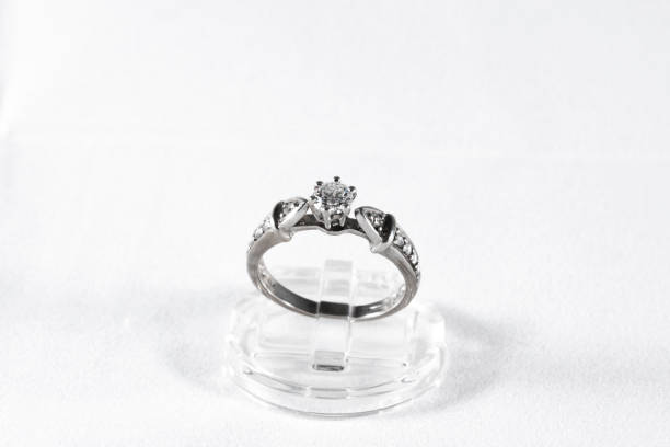 istock White gold ring with natural diamonds on a white background, engagement ring 1361897679